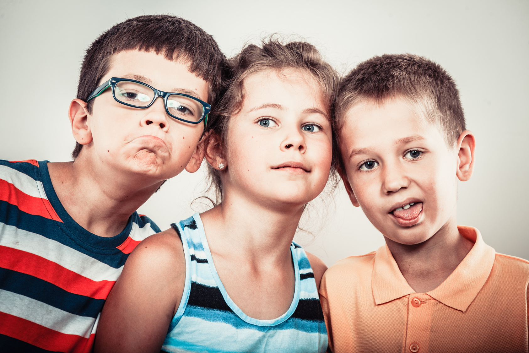 Kids little girl and boys making silly face expression.
